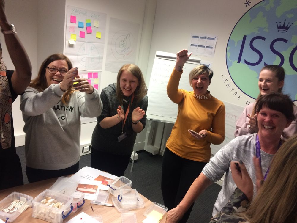 A team celebrating during an improvement workshop